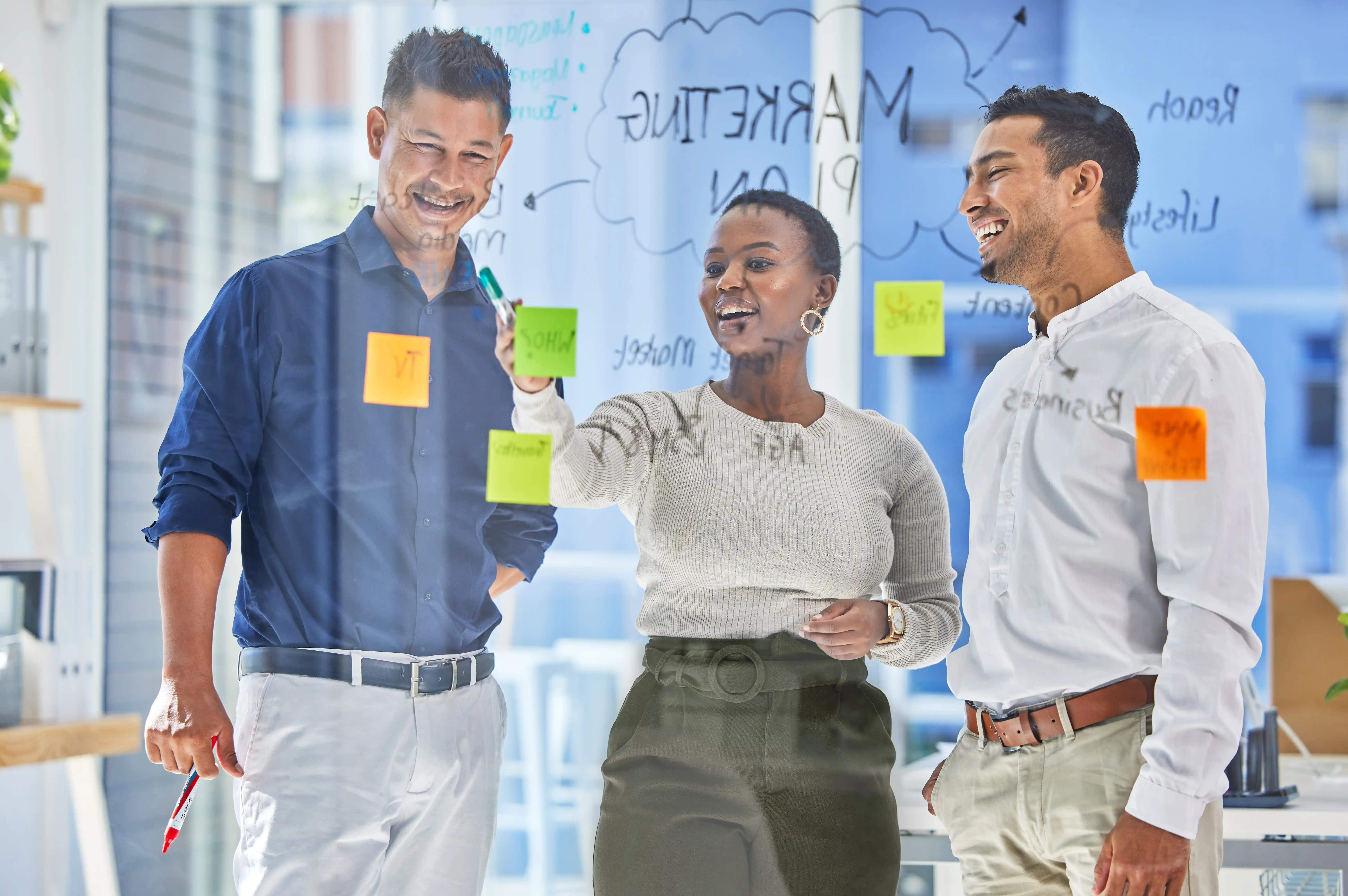 Team shaping campaign ideas on a glass board